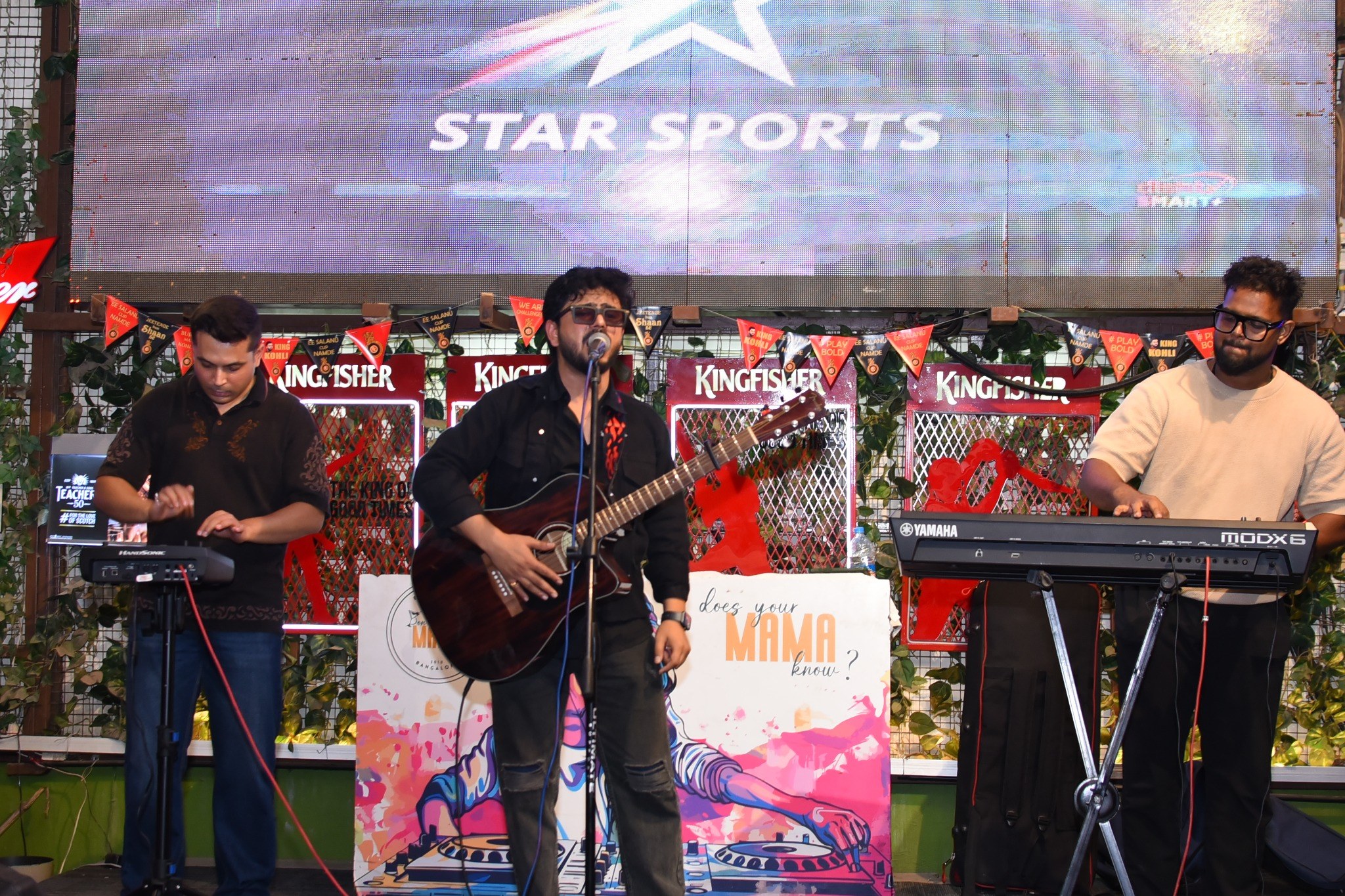 A band performing live on the rooftop stage